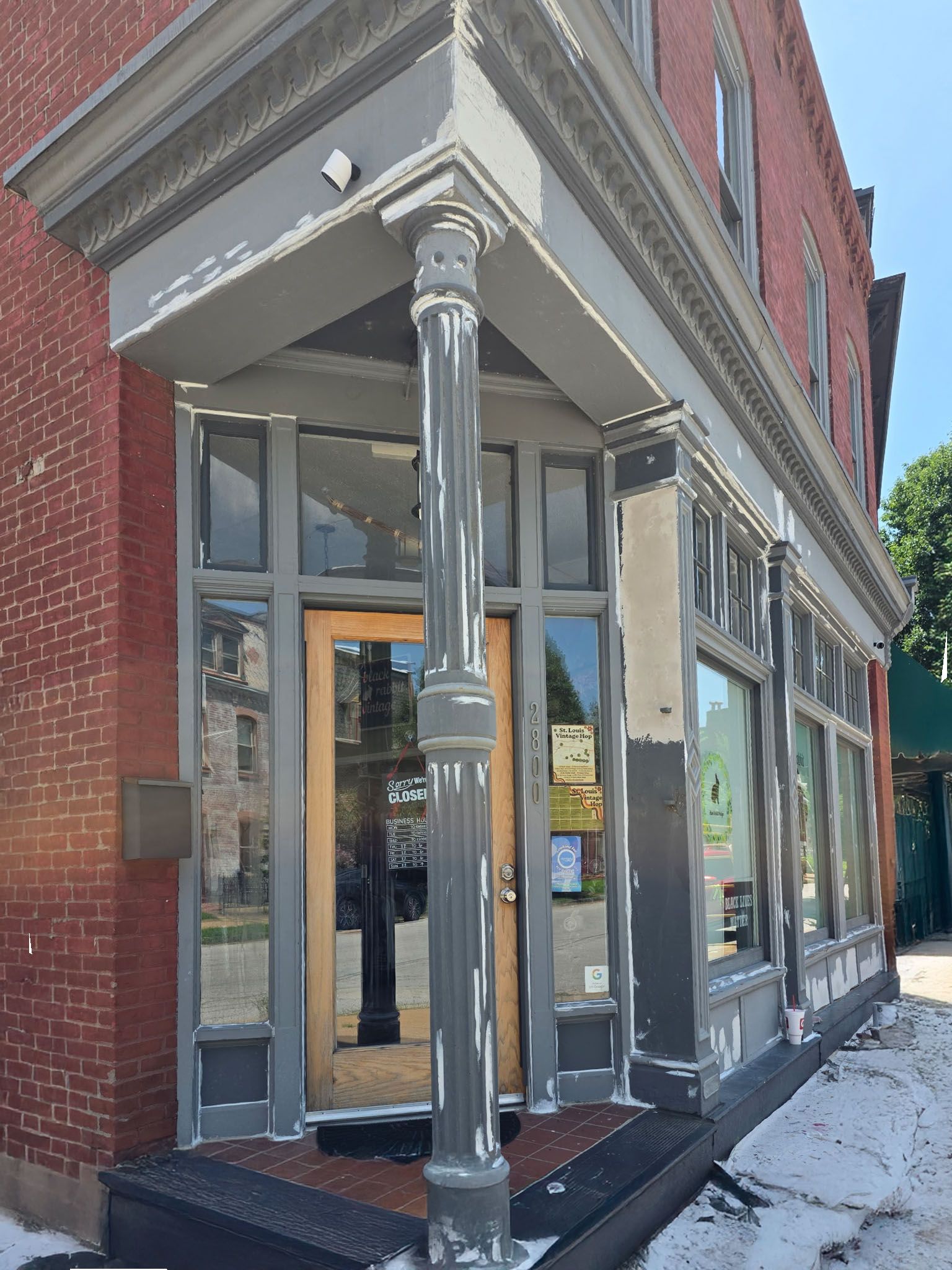 A brick building with a porch and a door