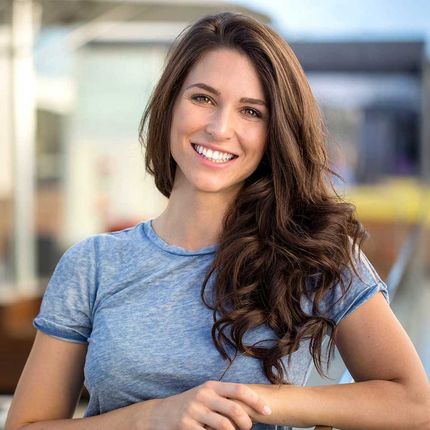 Big bright white smile headshot with a beautiful brunette woman sincere happy cheerful positive expression 
