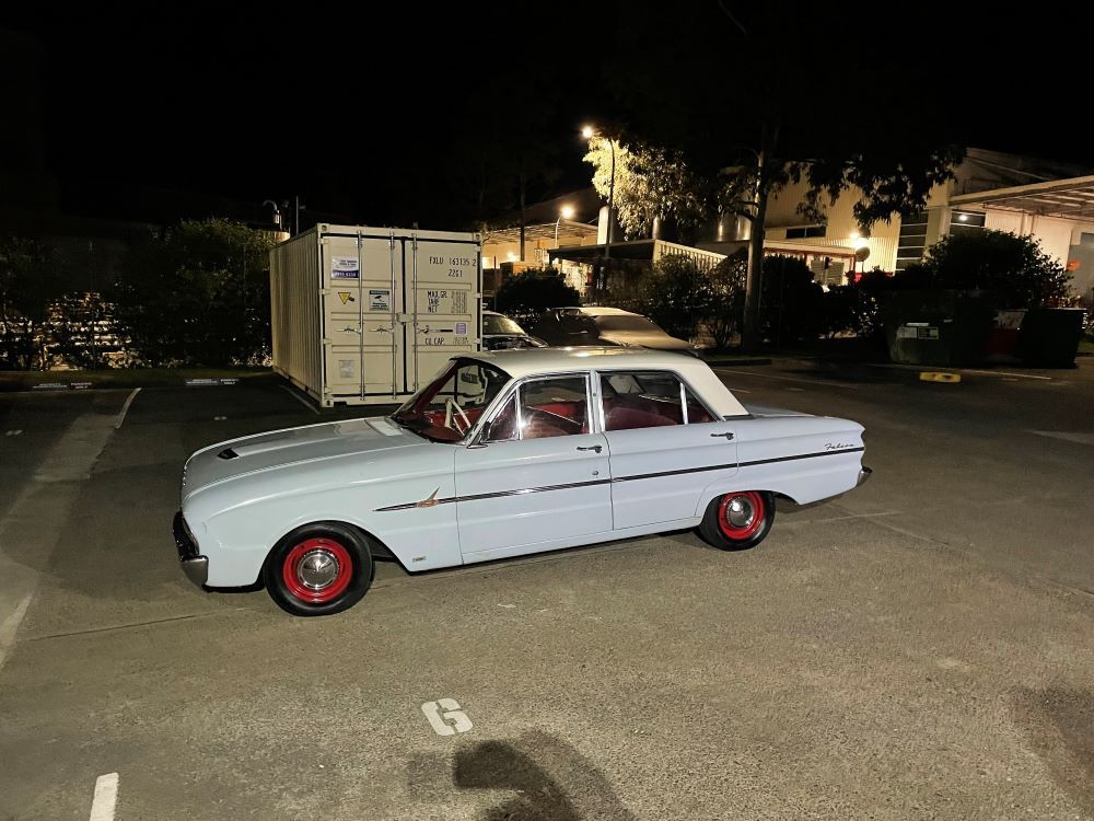 A White Car is Parked in a Parking Lot at Night — VR Mechanical in West Gosford, NSW