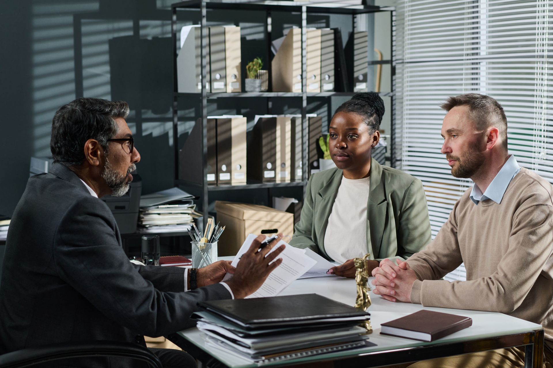 Two business professionals in suits reviewing documents, discussing strategy.