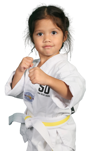 A young girl in a taekwondo uniform is posing for a picture.