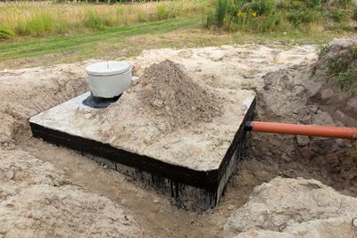 Septic Line Repair — Man Holding Hose For Cleaning Septic Tank in Lebanon, TN