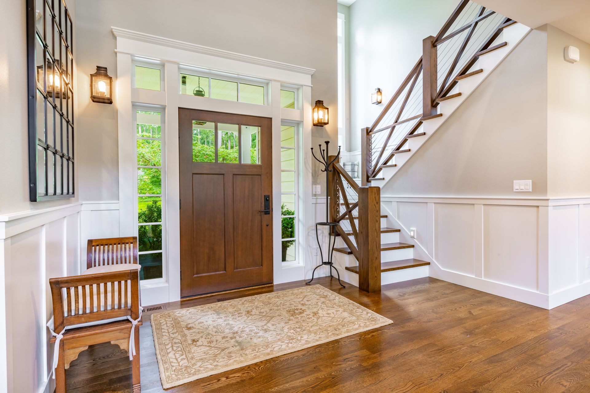 A hallway with a wooden door and stairs in a house.