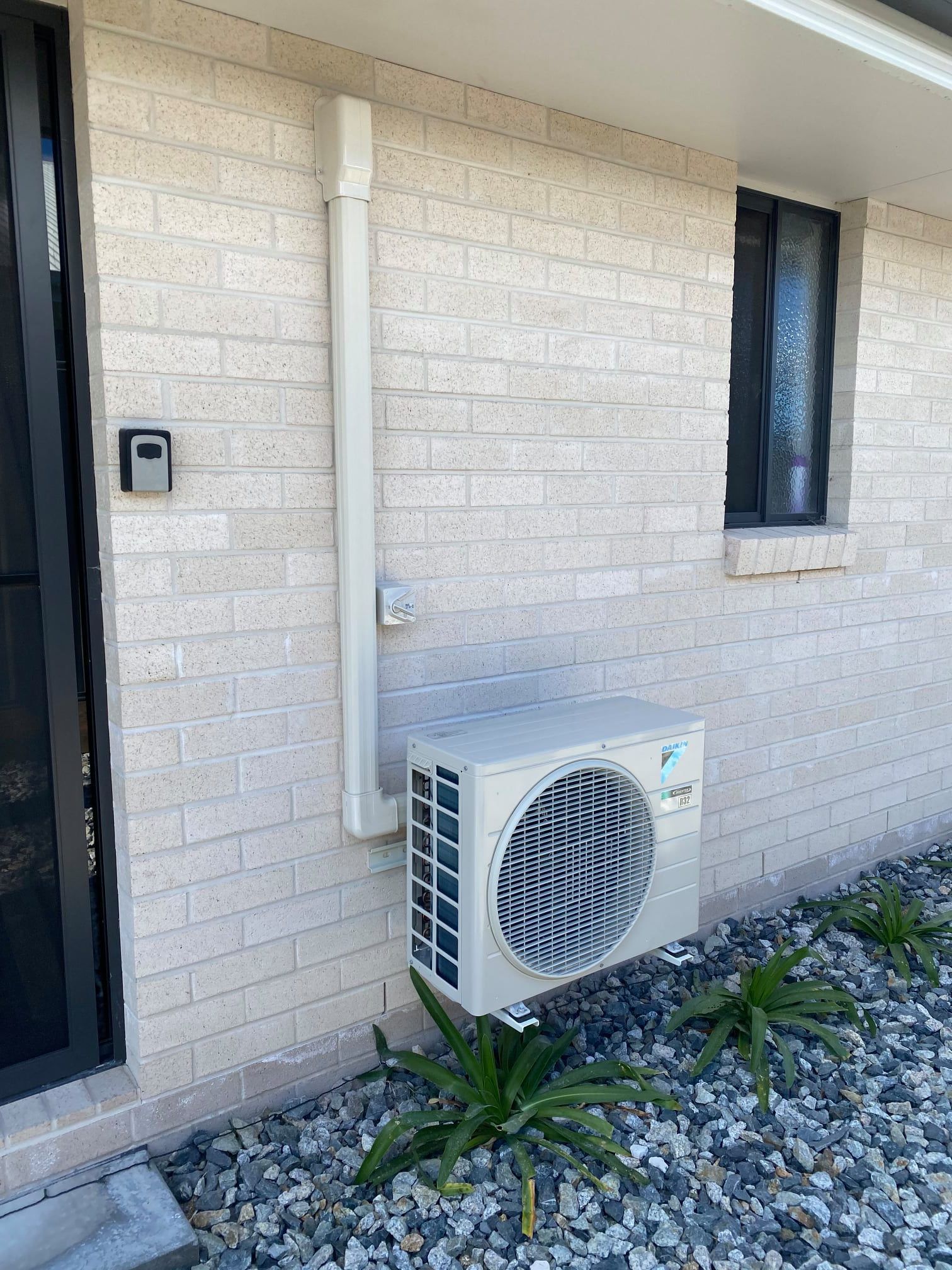 A White Window Air condition attached to the wall — Air Conditioning in Warwick
