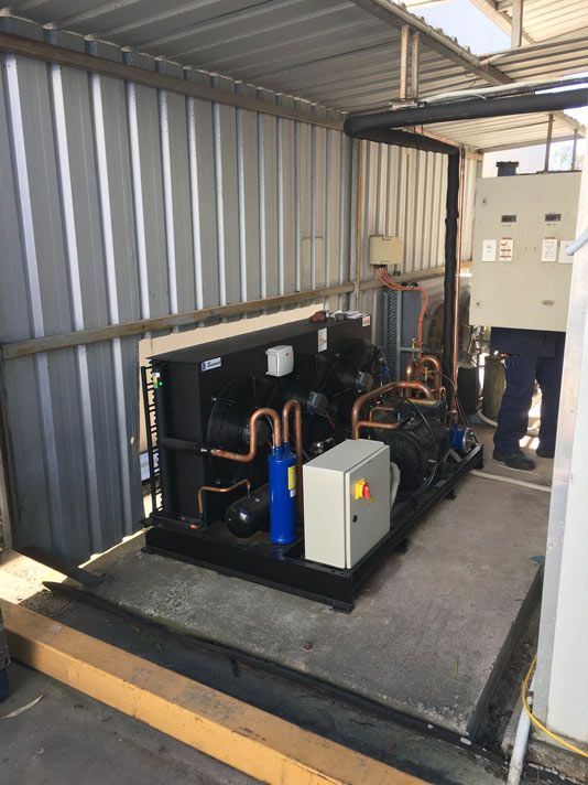 A Cooling Machine  is opened for Repair — Electrician in Warwick