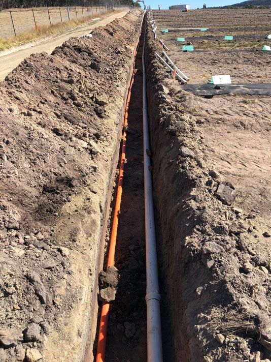 Two Electric Wire Pipe is being passed through the Pit — Electrician in Warwick