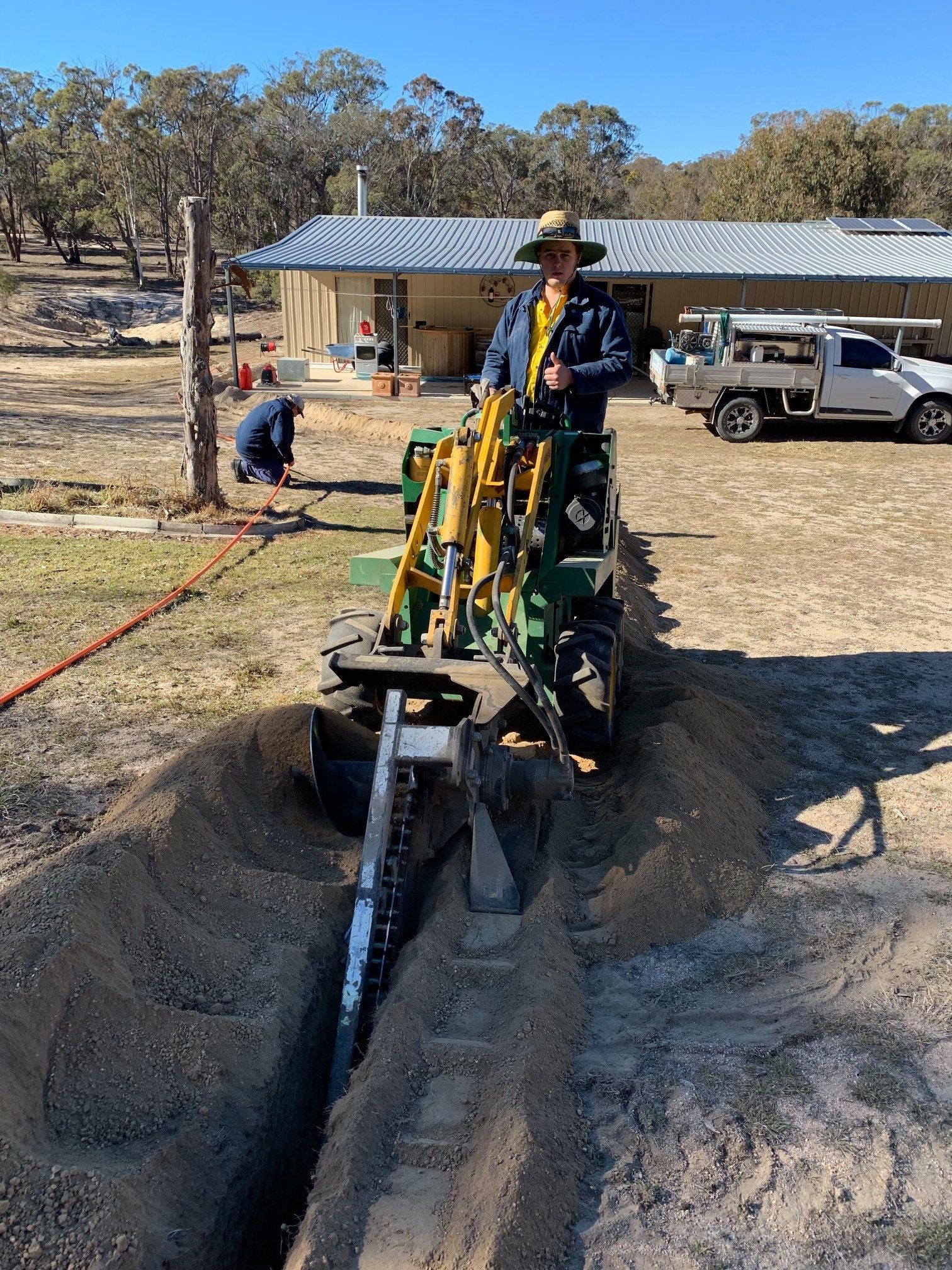 Man Working On Digging Electrical Piping Trench— Electrical Services in the Southern Downs