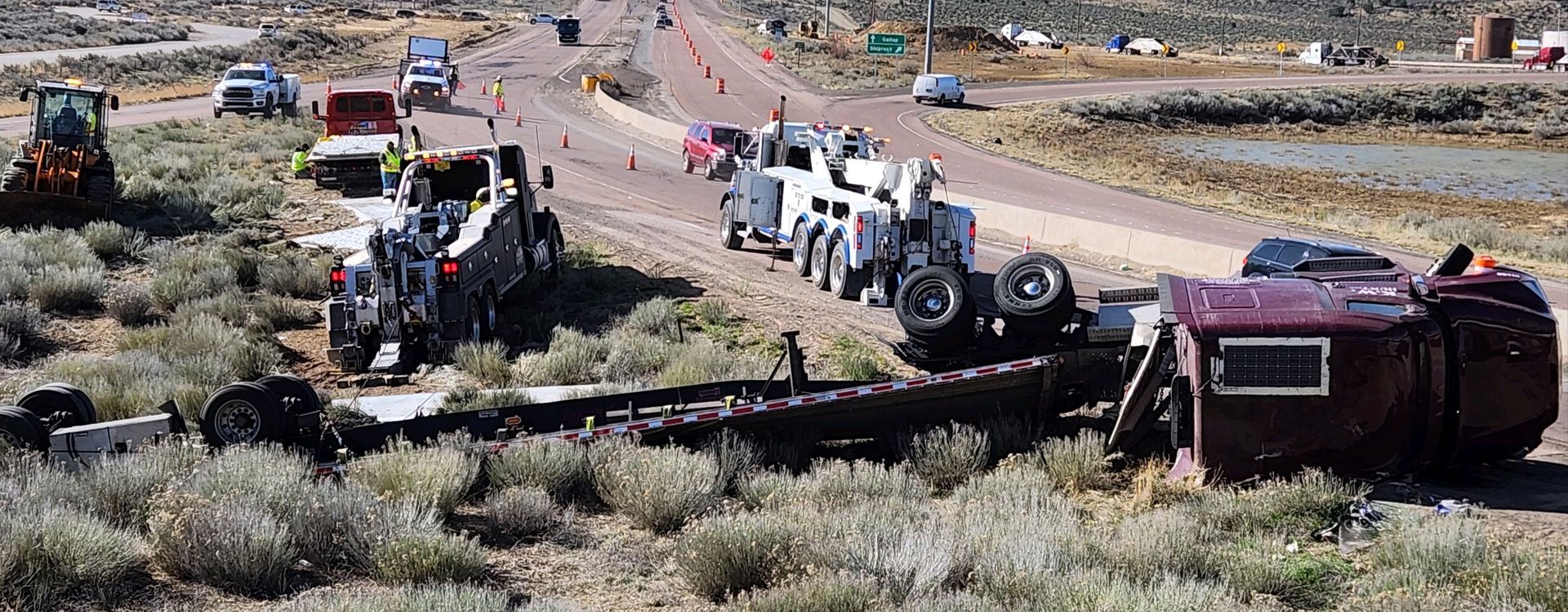 A truck has rolled over on the side of the road.