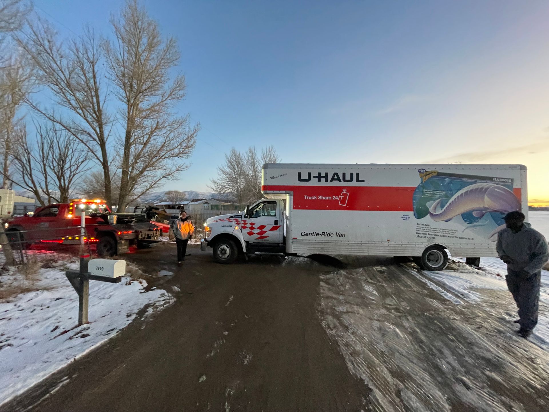 A uhaul truck is parked on the side of the road