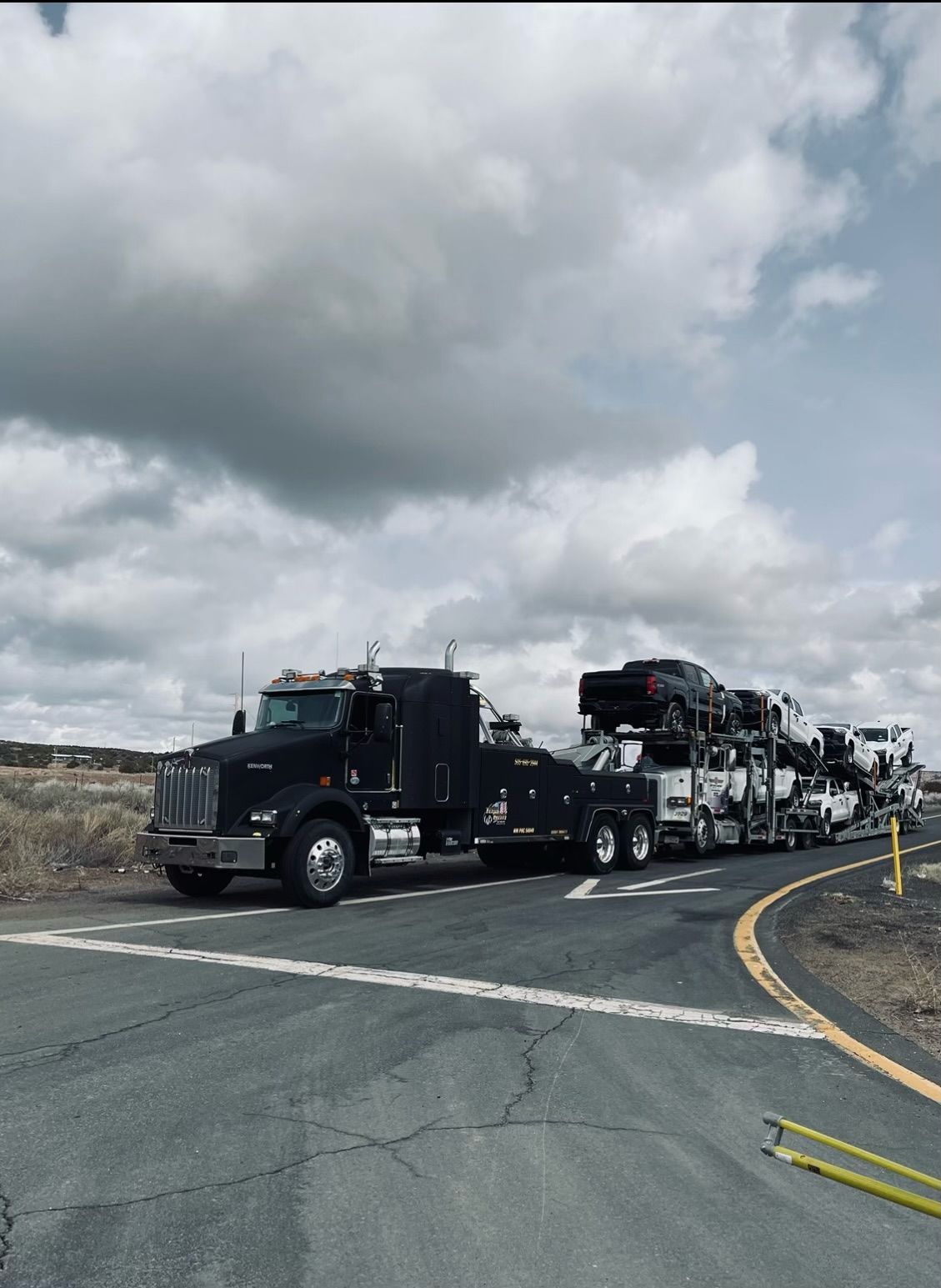 A row of trucks are parked on the side of the road