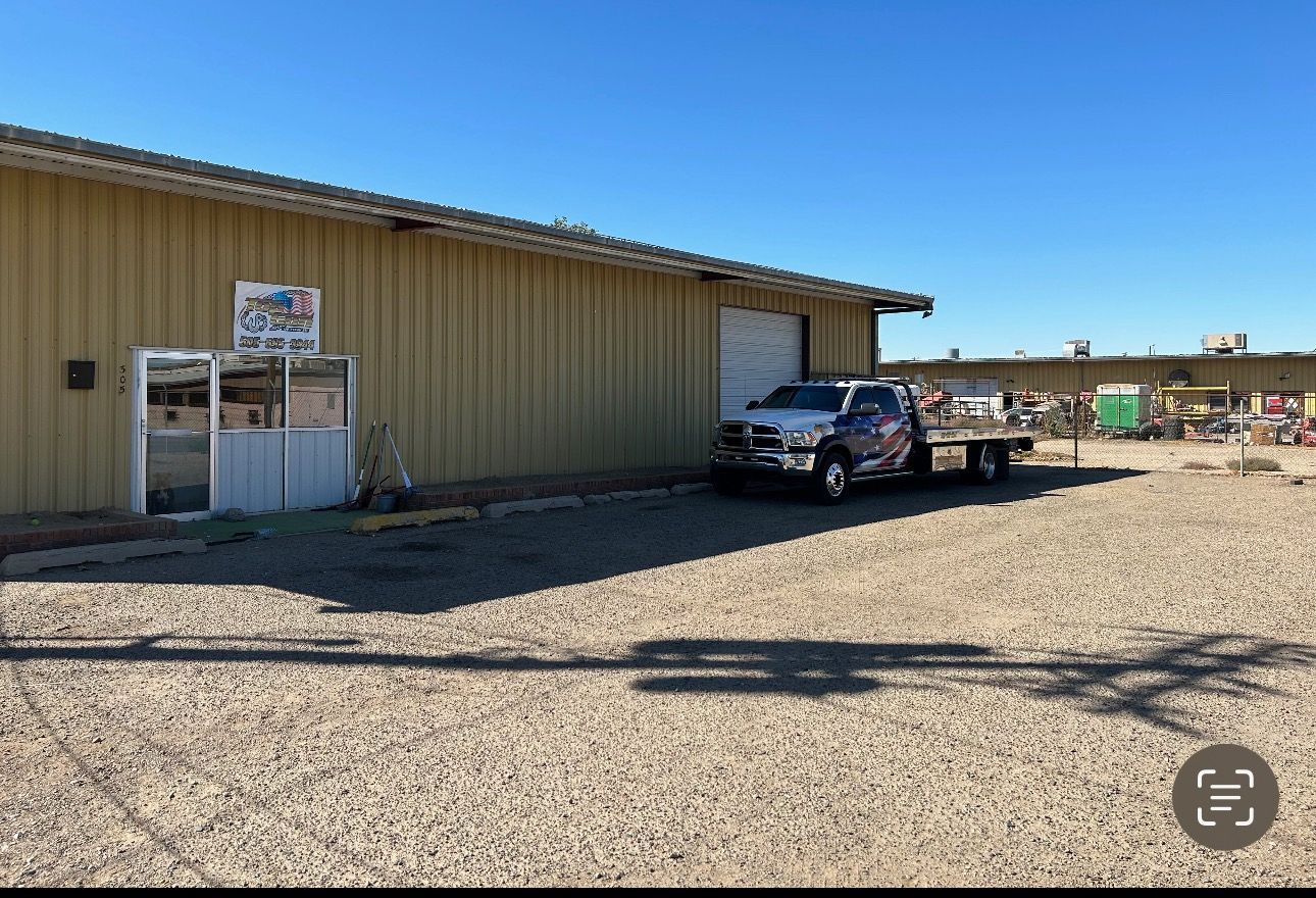 A truck is parked in front of a building.
