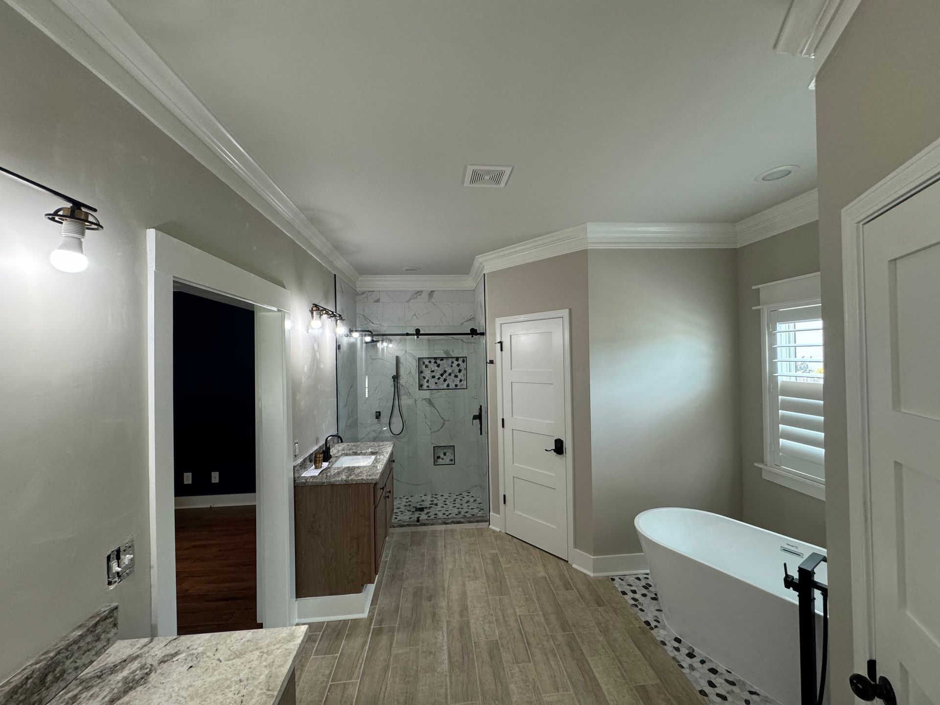 A bathroom with a tub , sink , and shower.