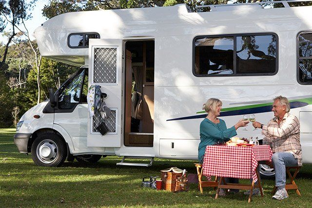 RV Insurance — Couple Having a Picnic beside their RV in Ferdinand, IN