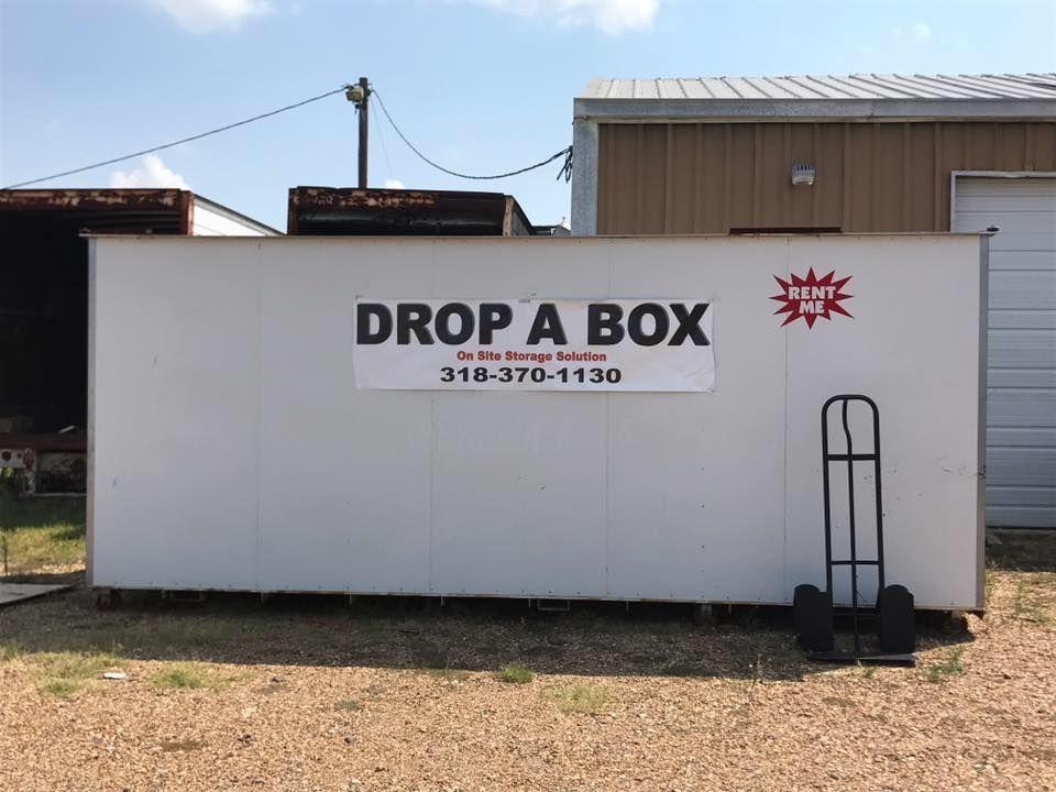 A white box with a sign on it that says `` drop a box ''.