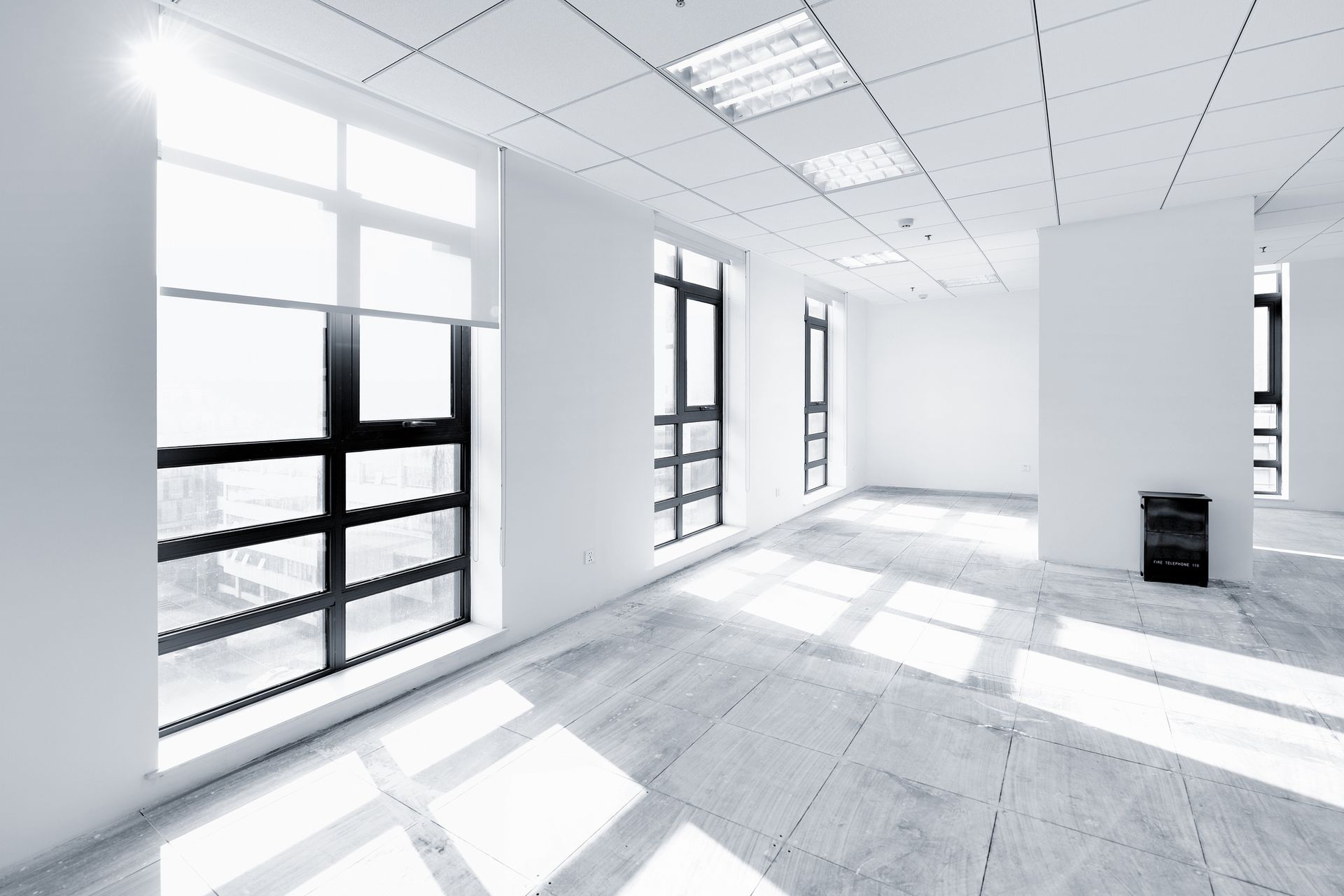 A large empty room with a lot of windows