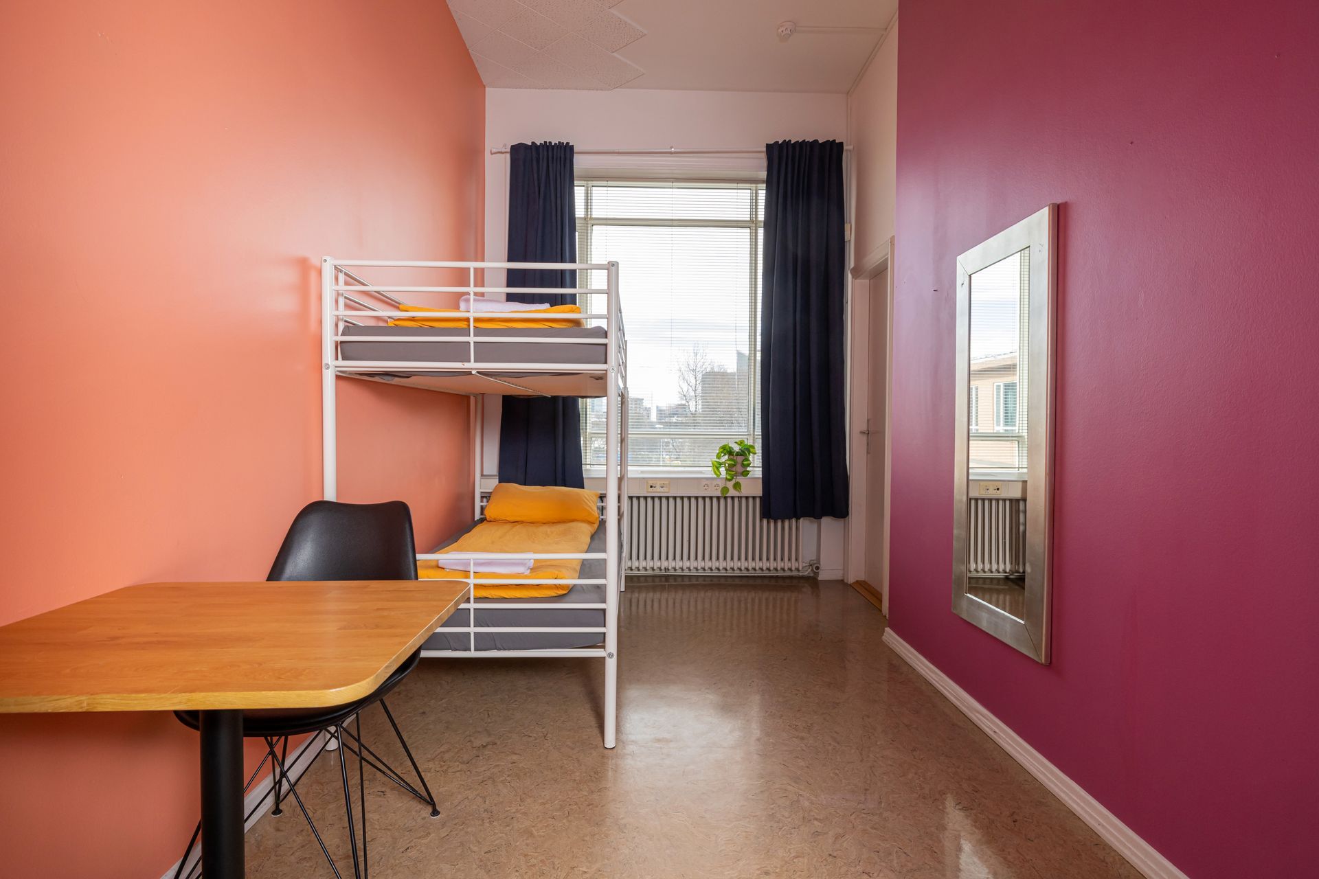 There is a bunk bed and a table in the room.