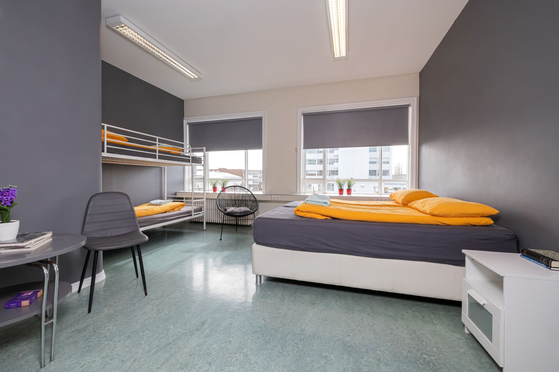 A bedroom with a bunk bed and a desk