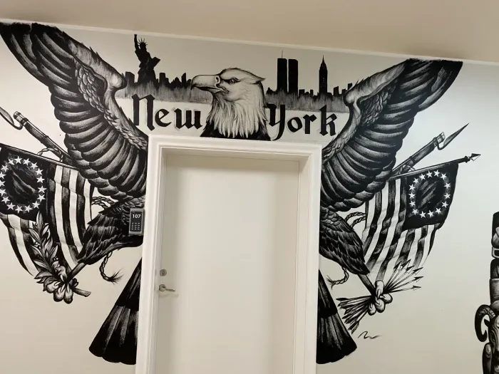 A black and white painting on a wall that says new york
