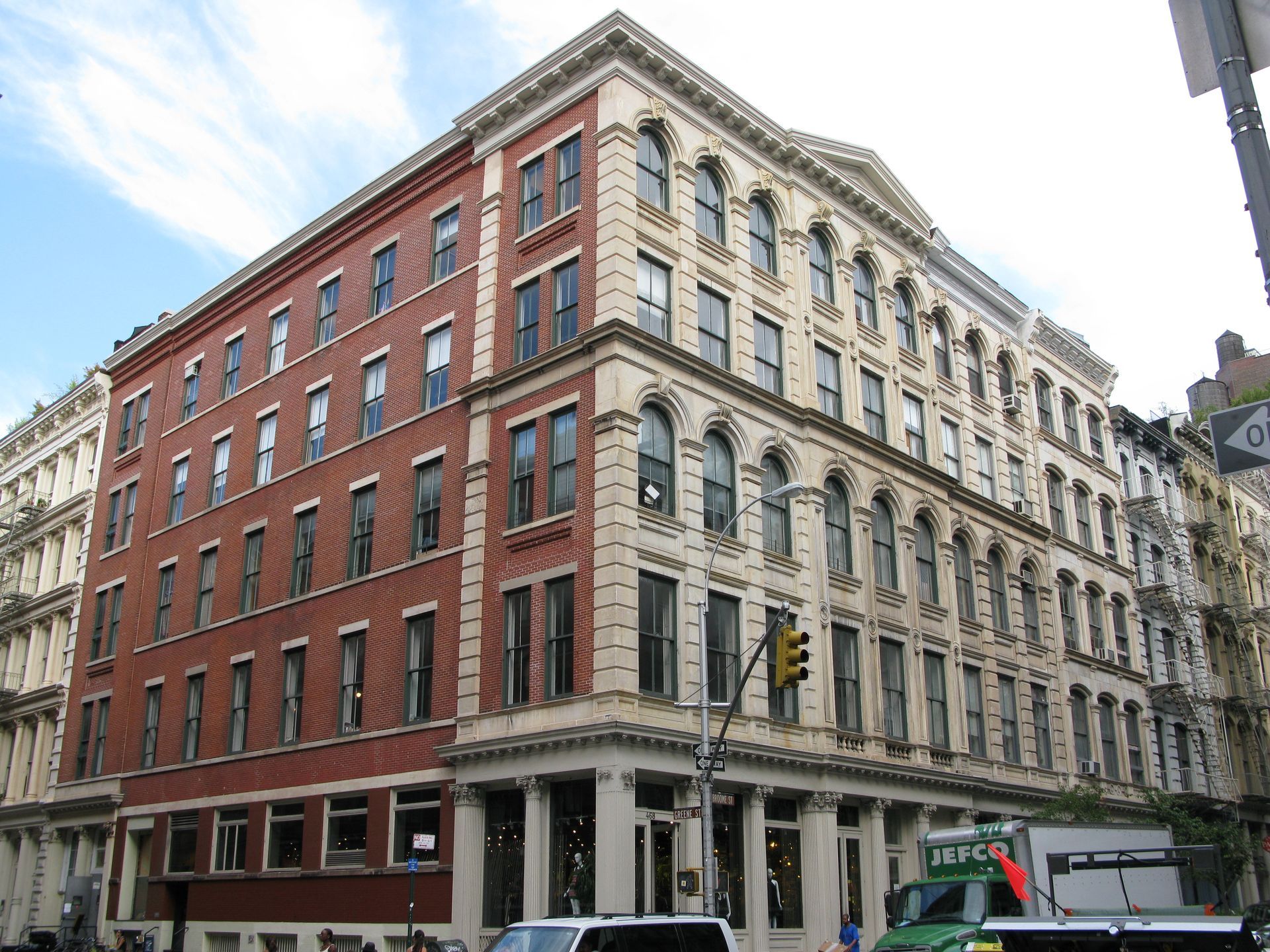 Brick building with a tall, metal fire escape running up the facade.
