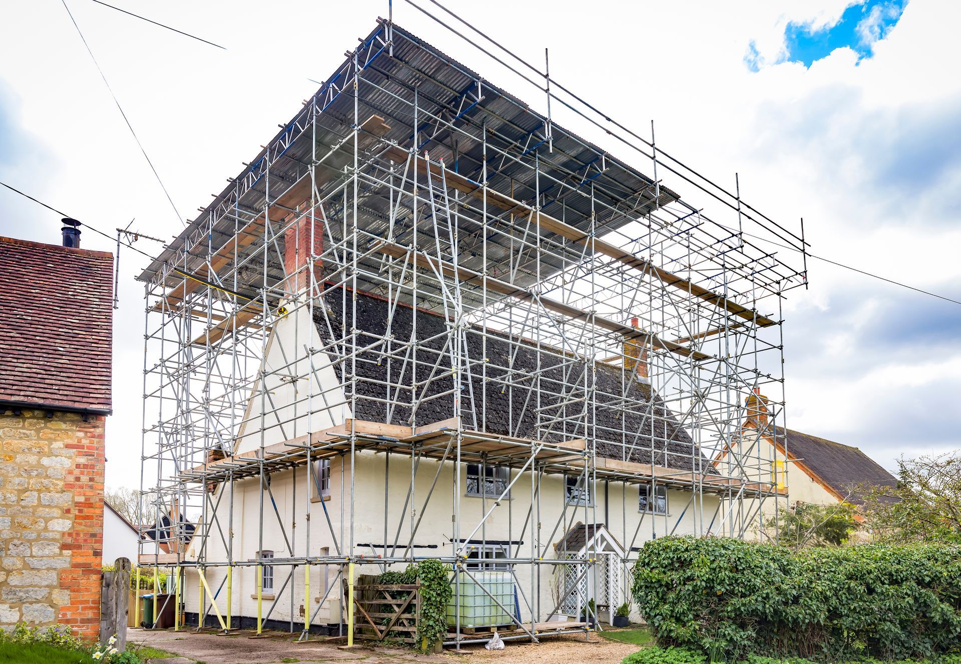 Roof scaffolding and temporary roof canopy over a house.