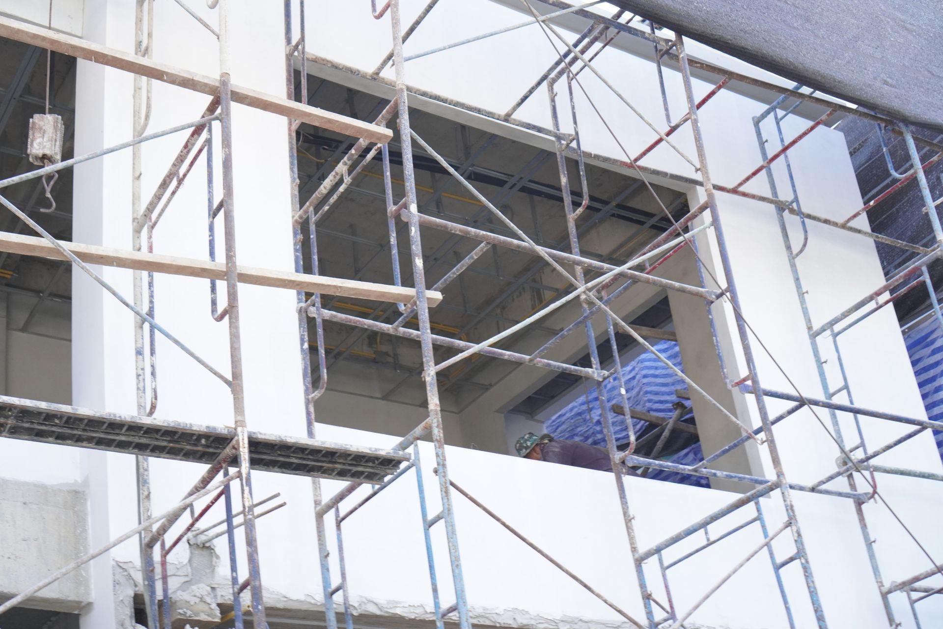 View From the Ground Up of a Scaffolding Frame on a Window Under Construction View From the Ground Up of a Scaffolding Frame on a Window Under Construction