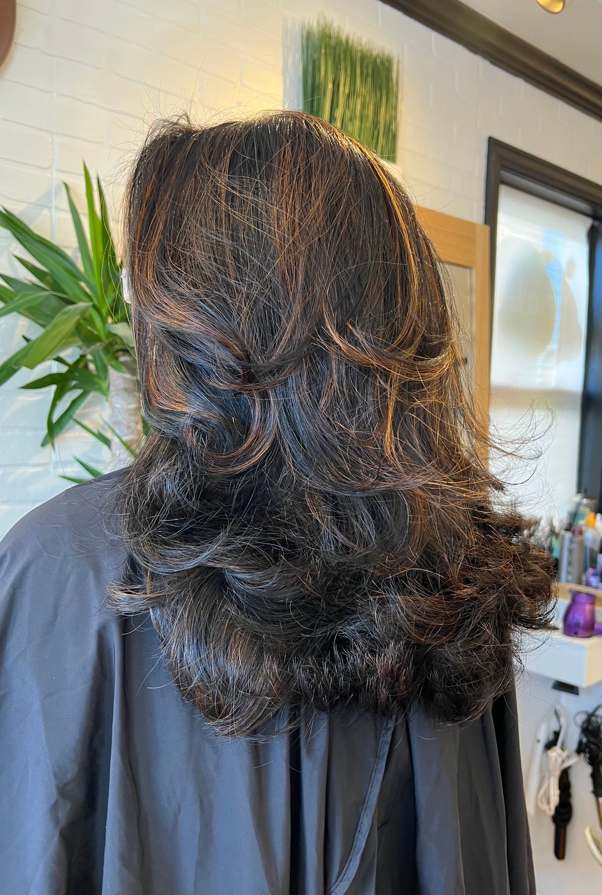 A woman is getting her hair done in a salon.
