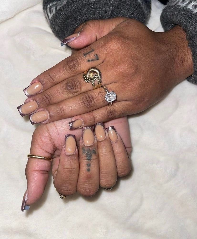 A close up of a person 's hands with rings on them