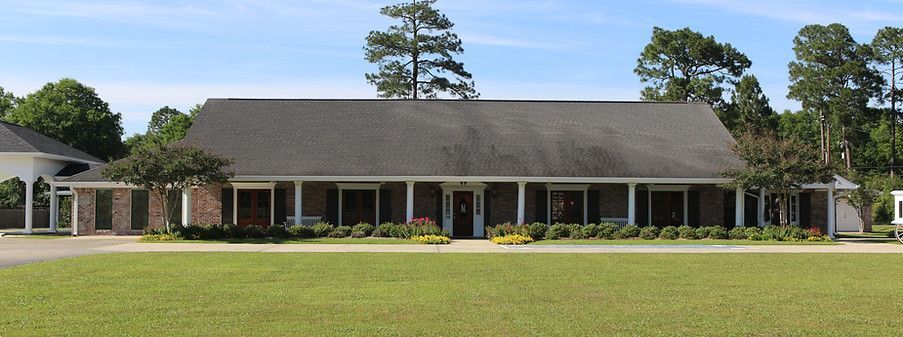 A large house with a large lawn in front of it