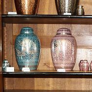 A shelf filled with vases and urns of different sizes.