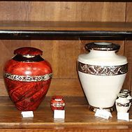 Two vases are sitting on a wooden shelf.