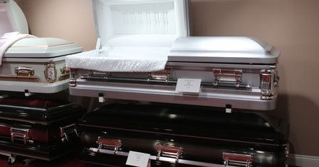 A row of coffins are sitting on top of each other in a room.