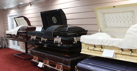 A row of coffins are sitting on top of each other in a room.