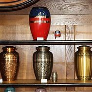 A shelf filled with urns of different sizes and colors.