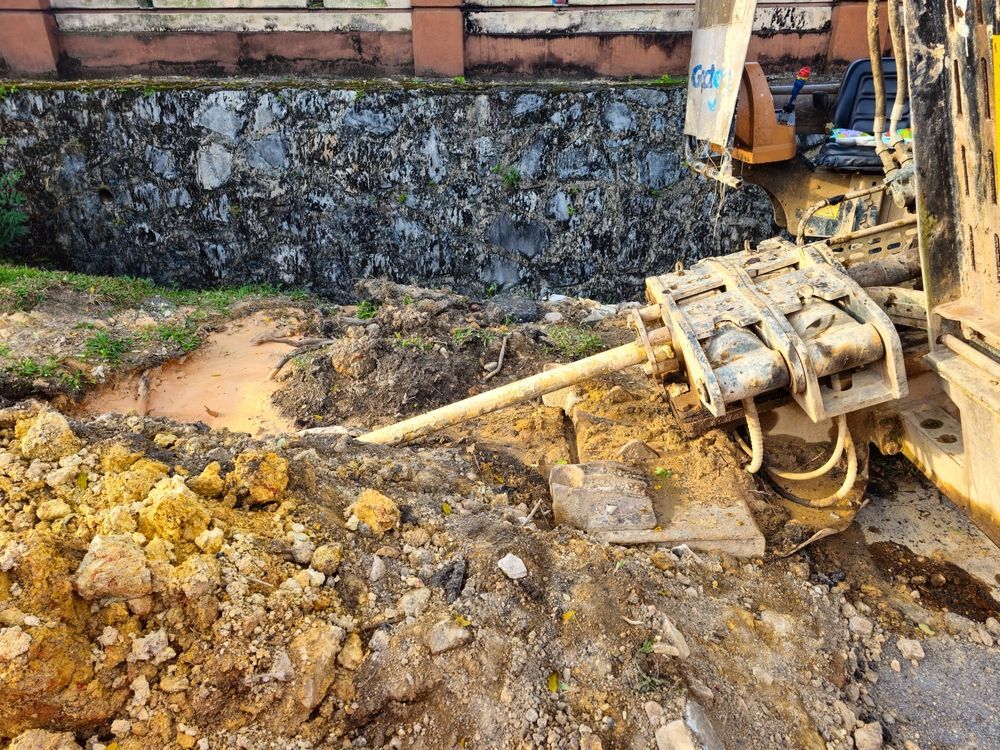 A bulldozer is sitting on top of a pile of dirt.