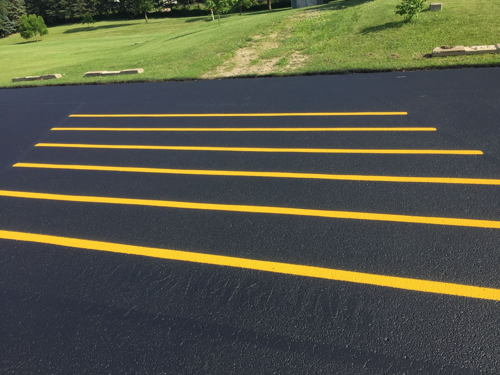 A row of yellow lines on a black road