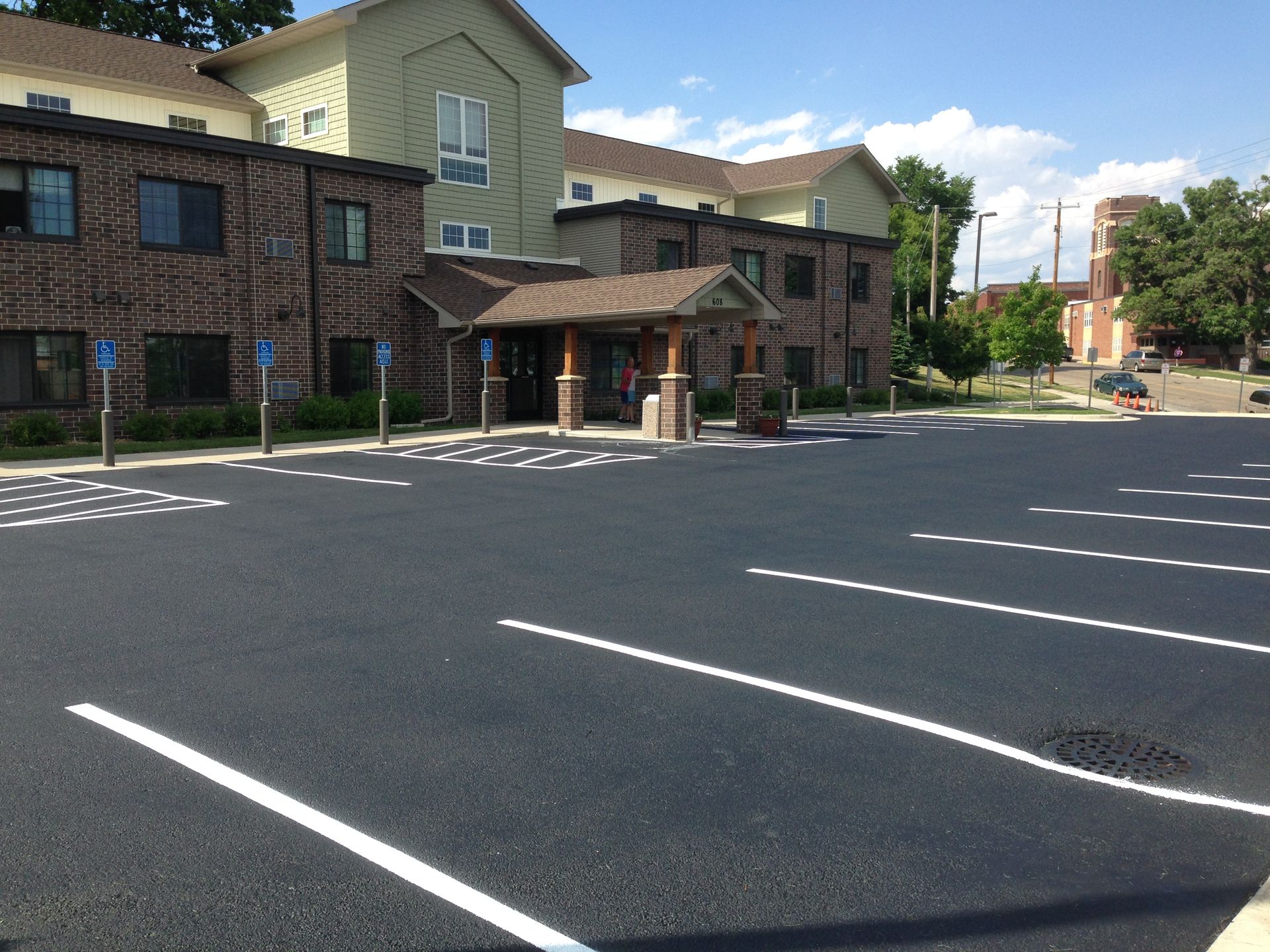 A large building with a parking lot in front of it