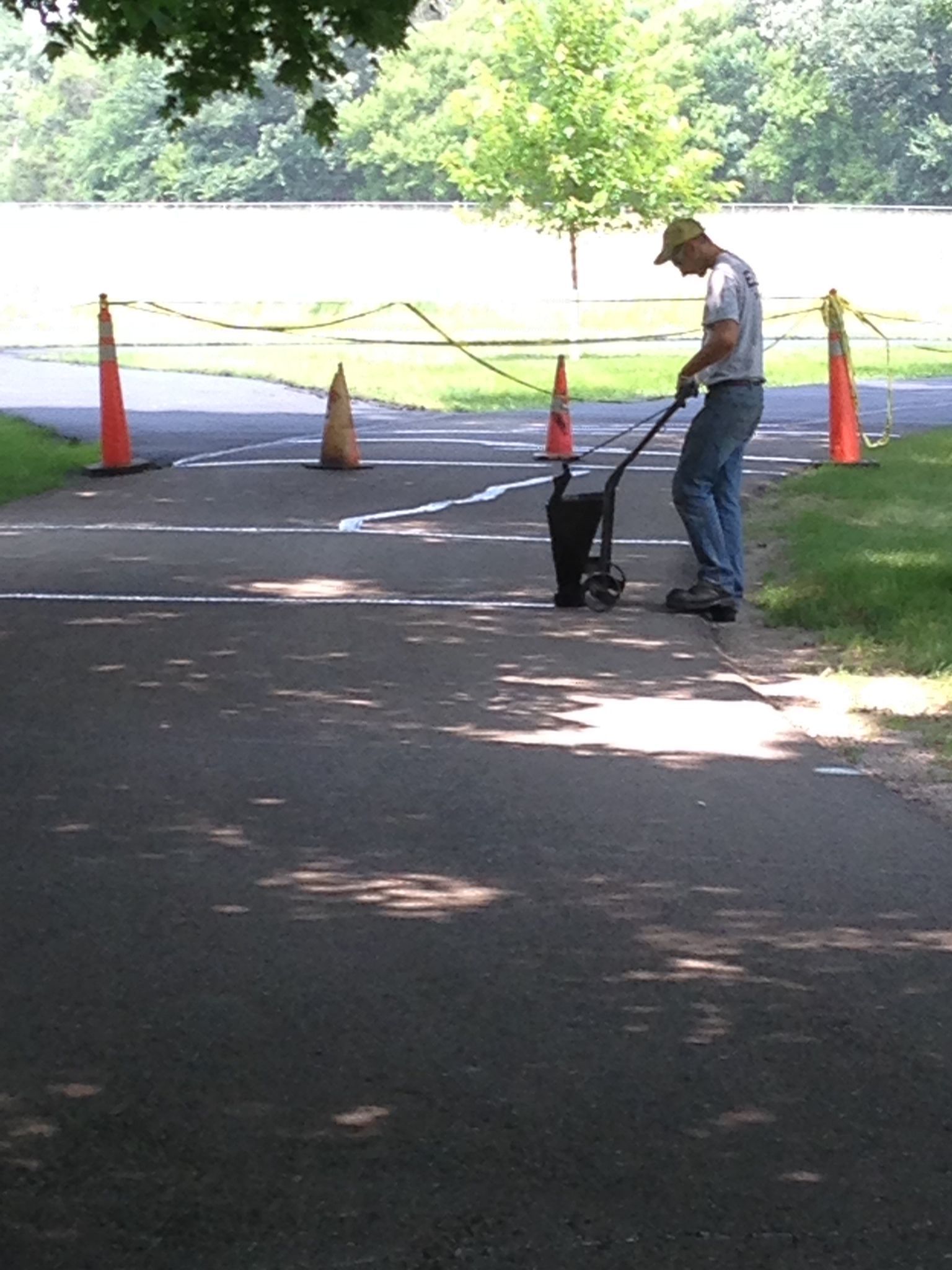A man is painting a line on the road