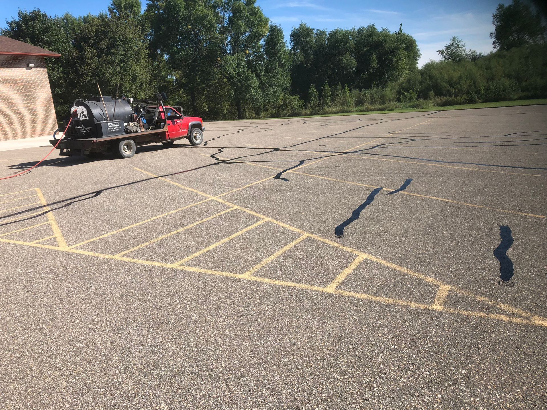 A red truck is parked in a parking lot.