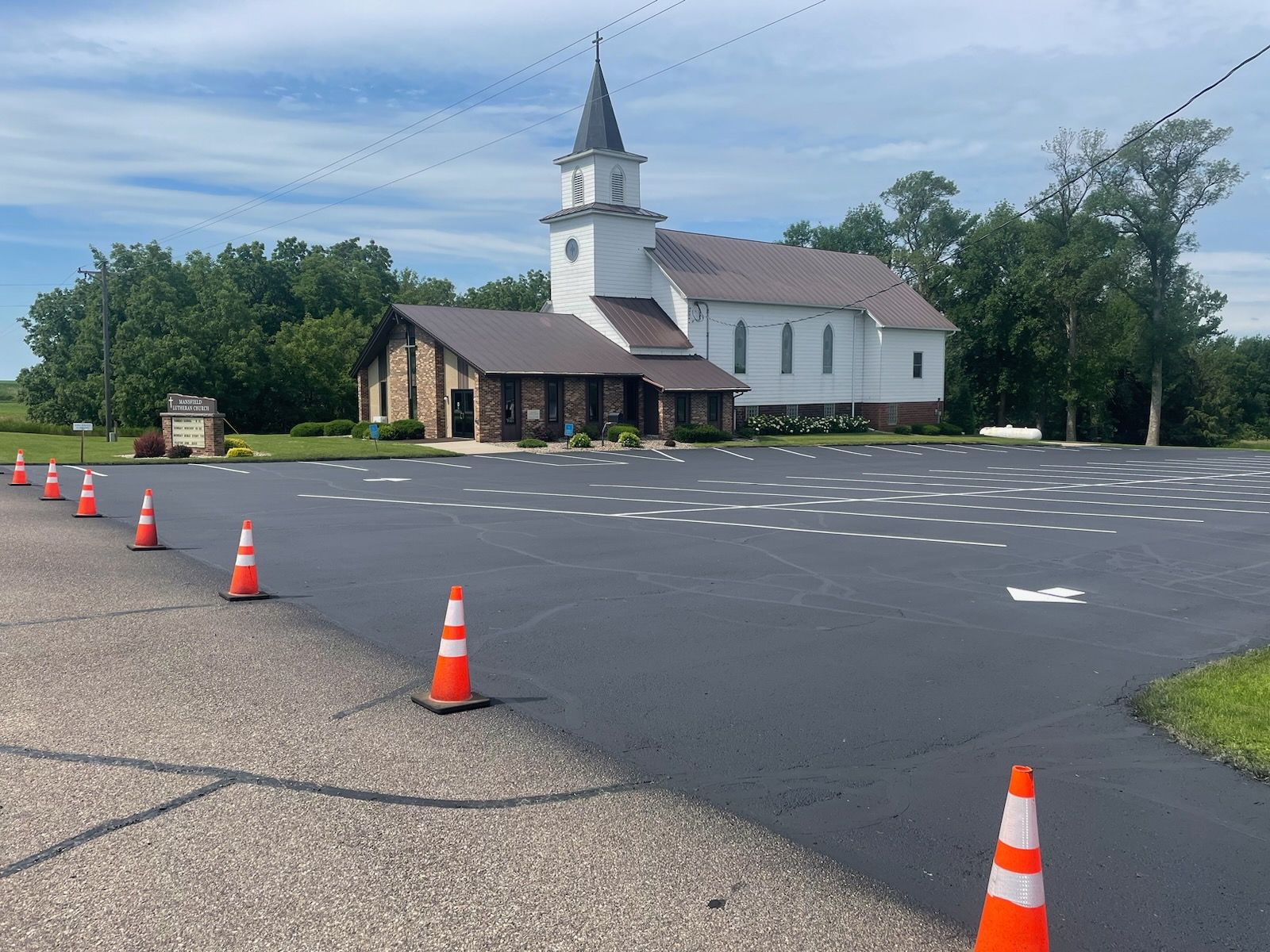 A row of yellow lines on a black road