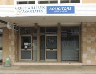 Exterior of Geoff Williams & Associates Solicitors office. Blue and white sign above a glass door and window. Exterior of Geoff Williams & Associates Solicitors office. Blue and white sign above a glass door and window.