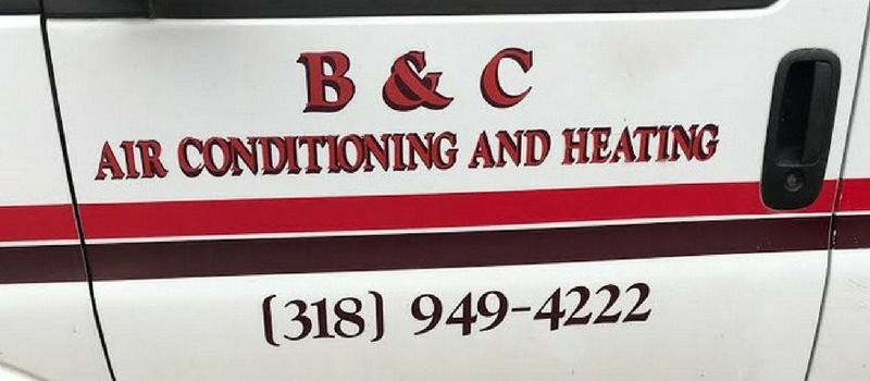 B & C Air Conditioning and Heating company logo with phone number on a white van door. Red and black accents.