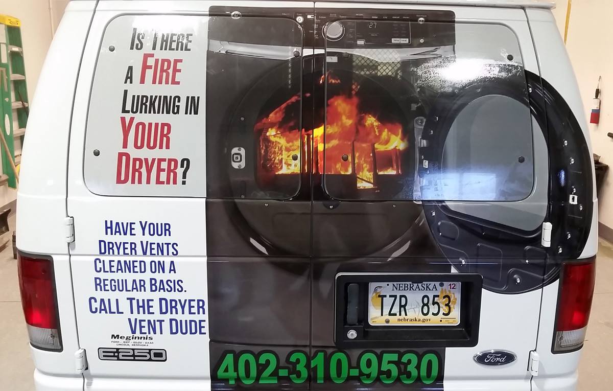 A white van with a picture of a fire on it
