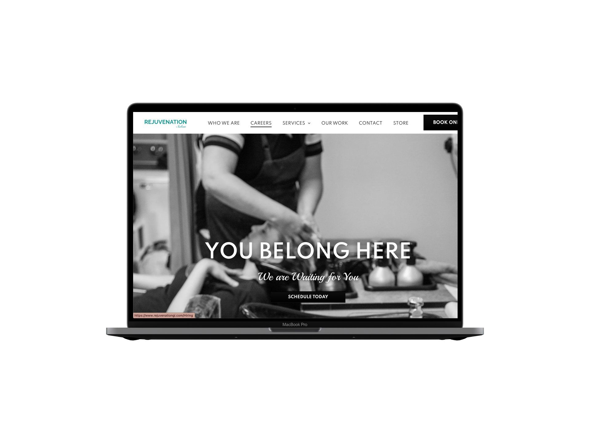 A laptop computer is open to a website that says `` you belong here ''.