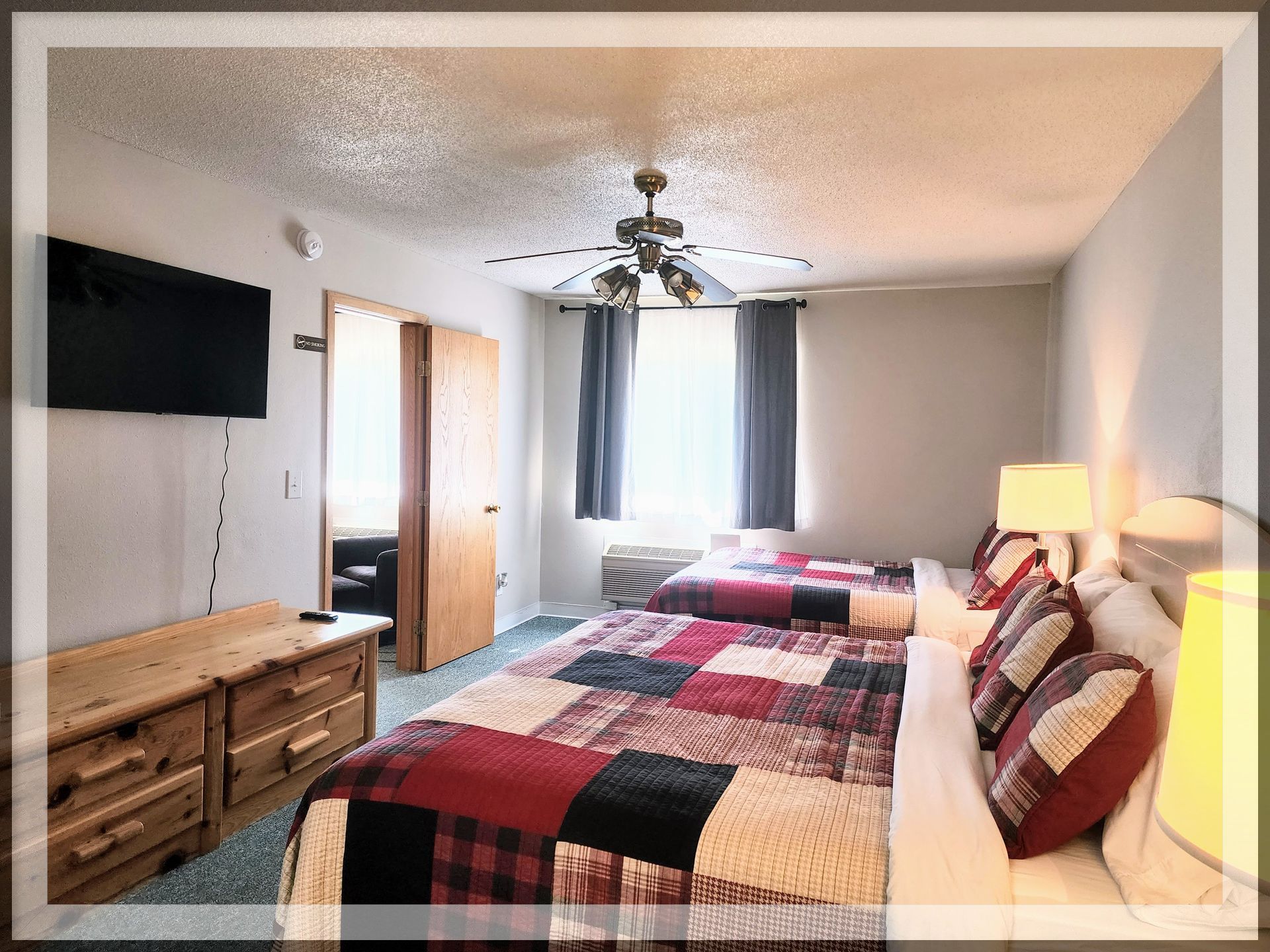 This is the bedroom image in the Extended Stay Suite, which has 2 queen beds and 2 bathrooms.