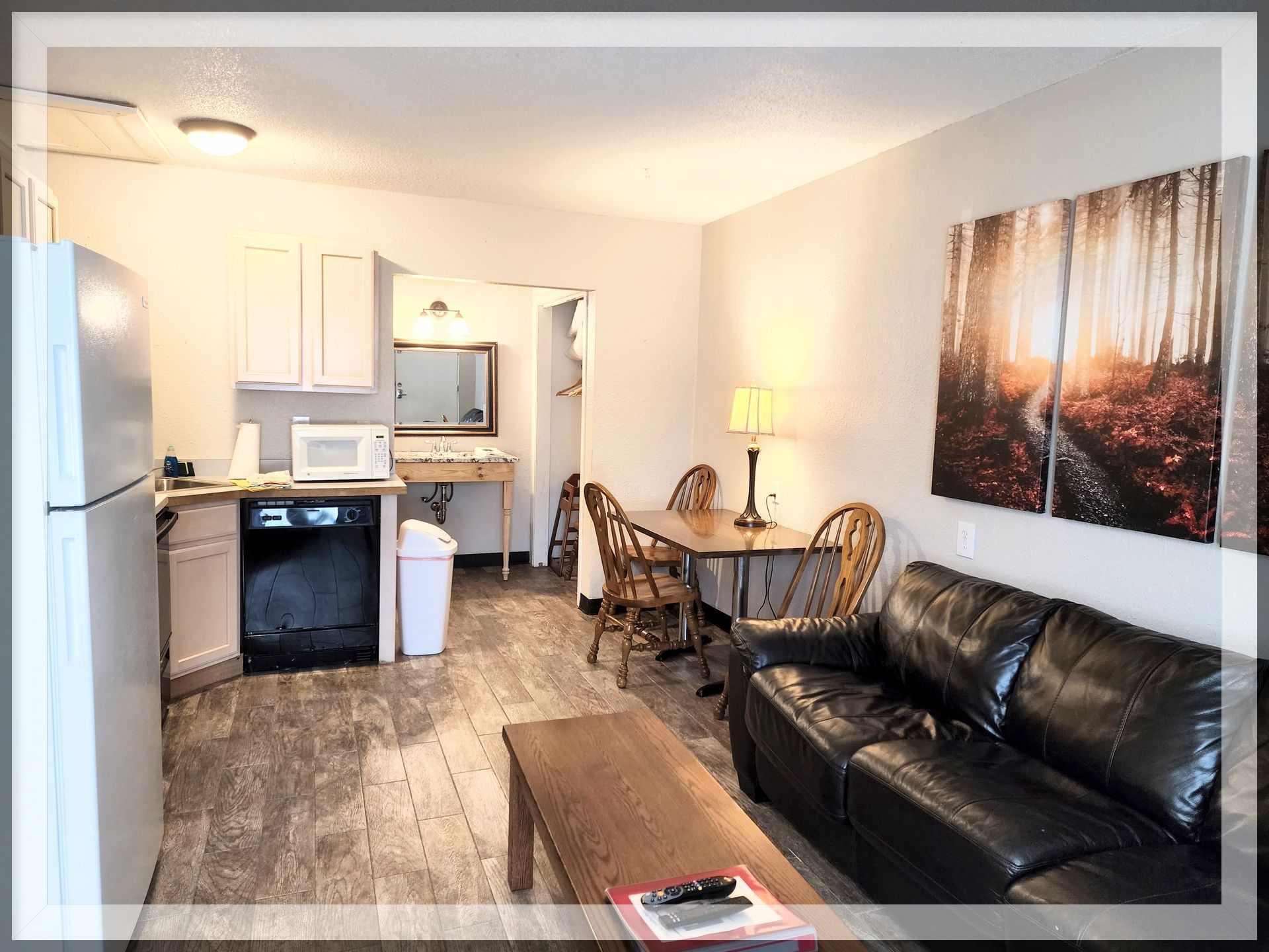 This is the living room with a kitchen in the extended-stay Suite with 2 queen beds and two bathrooms.