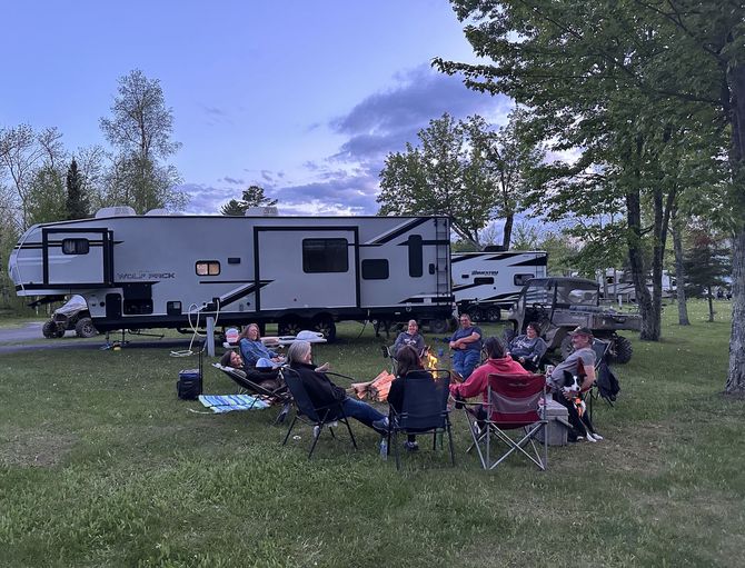 An image of a family, RV & SxS on the Trails Inn Quadna Mountain RV Campground.
