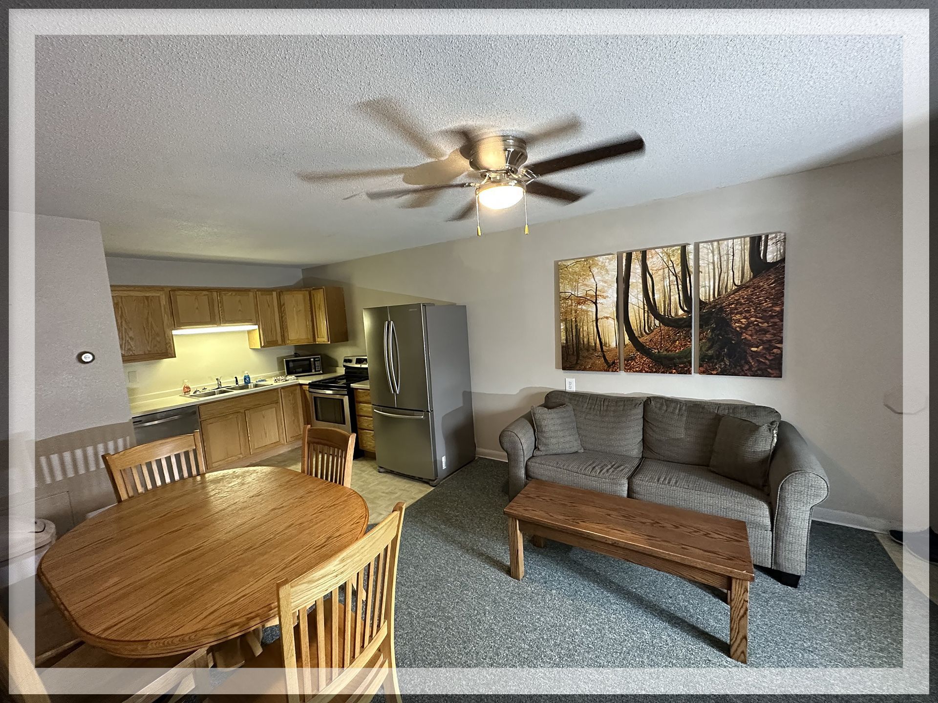 This is a living room and kitchen image of the 1 king bed, 1 queen bed, and 1 bathroom Extended Stay Suite.