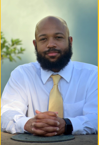 a man with a beard wearing a white shirt and yellow tie