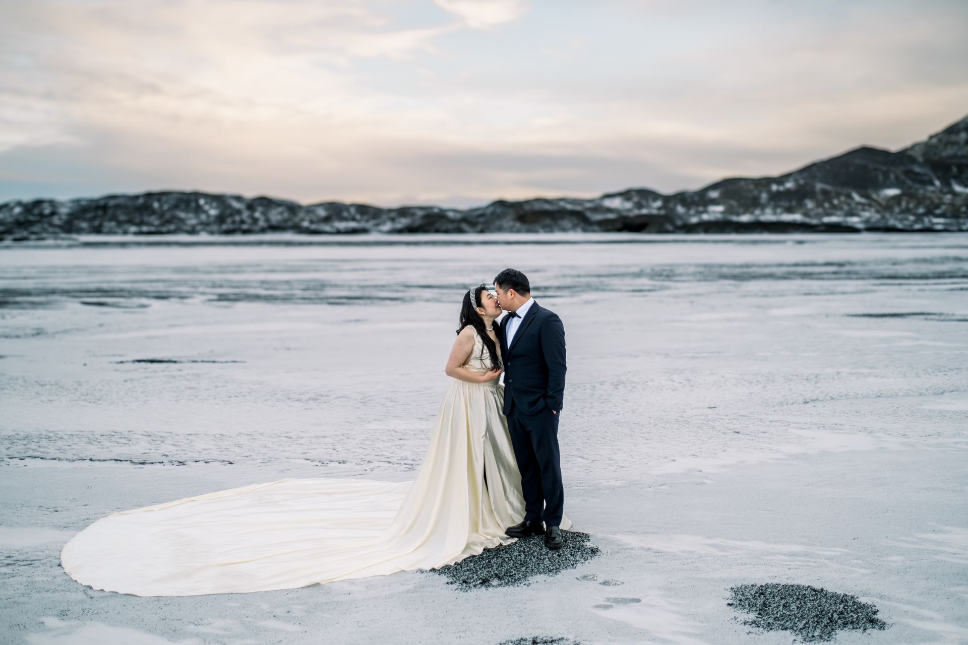 Asian couple kissing in the stunning landscape of Iceland