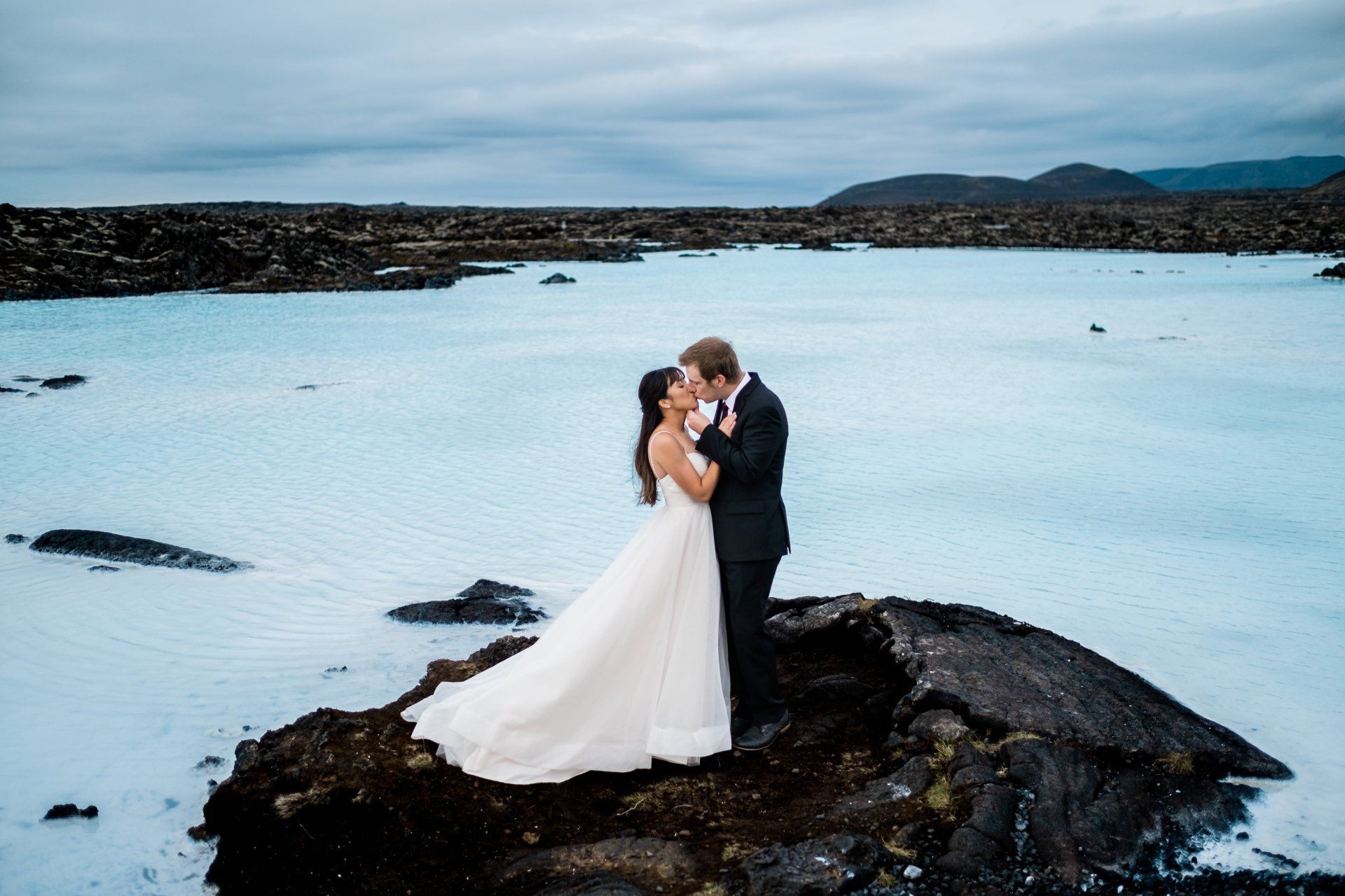 Married couple is kissing at Blue Lagoon in Iceland. Iceland elopement and wedding photographer